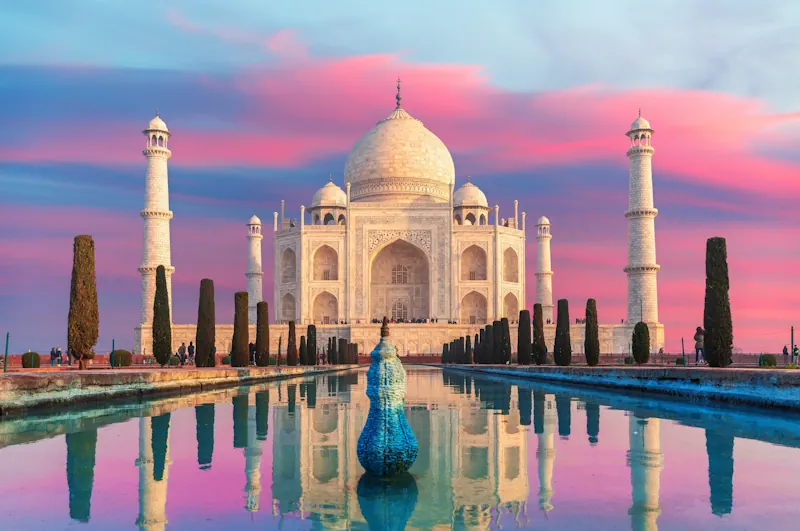 Photo of the Taj Mahal in India, over a pink sky