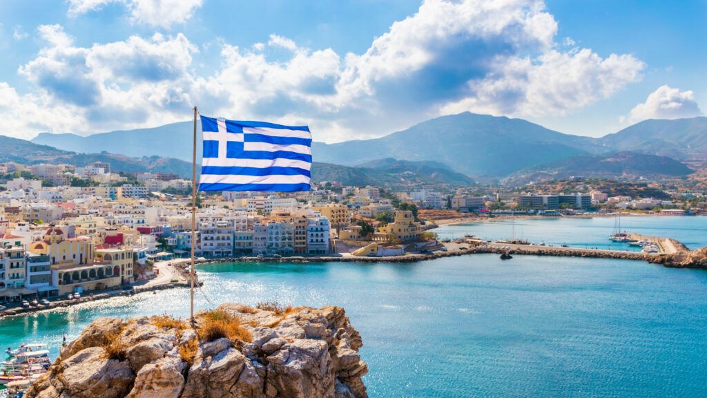 Panoramic view of Pagadia Bay and Harbor, with the Greek flag at the front