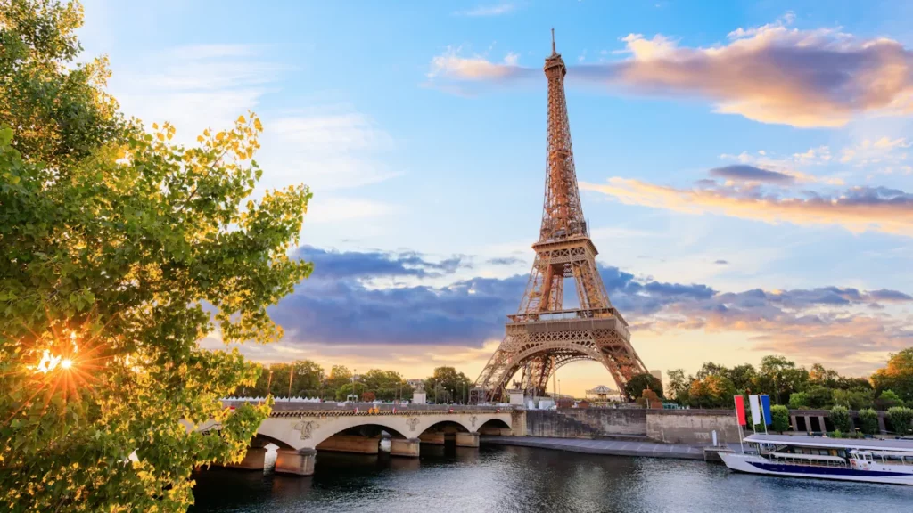 Photo of the Eiffel Tower and of a bridge spanning over the Seine river in Paris, capital city of France