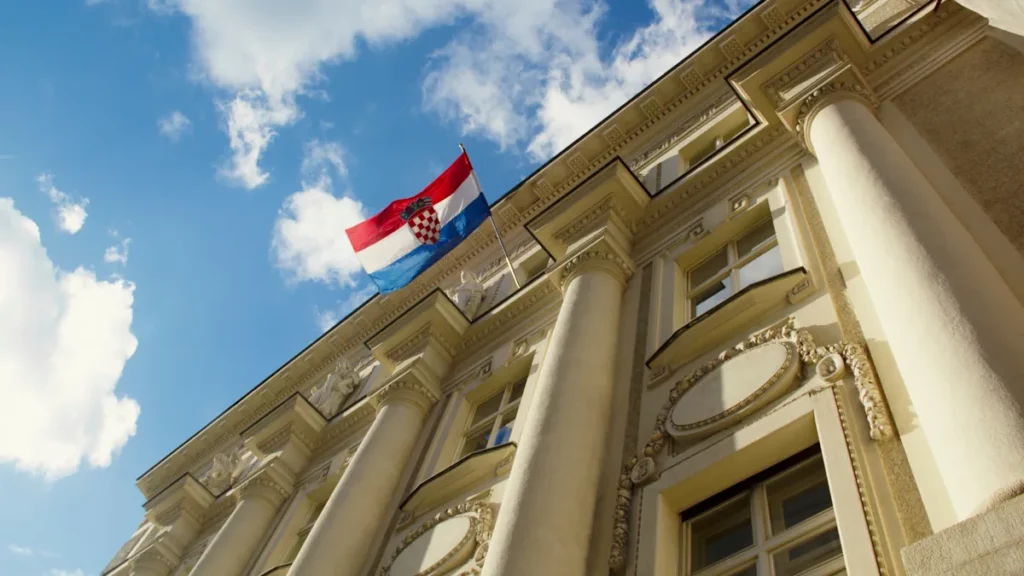 Croatian flag waving on top of the Central Bank building in Zagreb, capital of Croatia