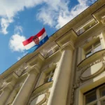Croatian flag waving on top of the Central Bank building in Zagreb, capital of Croatia