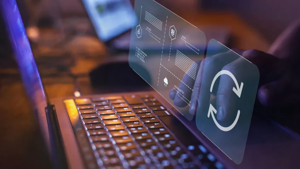 Update and maintenance icons virtually laid over a person typing on his laptop