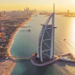 Aerial view of Burj Al Arab Jumeirah Island with downtown skyline in Dubai, United Arab Emirates
