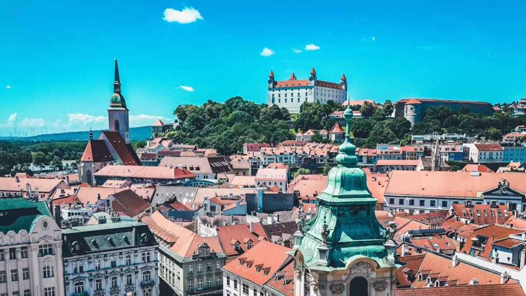 View of Bratislava’s historic Old Town, featuring St. Martin’s Cathedral and Bratislava Castle overlooking the city skyline.