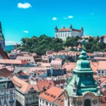 View of Bratislava’s historic Old Town, featuring St. Martin’s Cathedral and Bratislava Castle overlooking the city skyline.