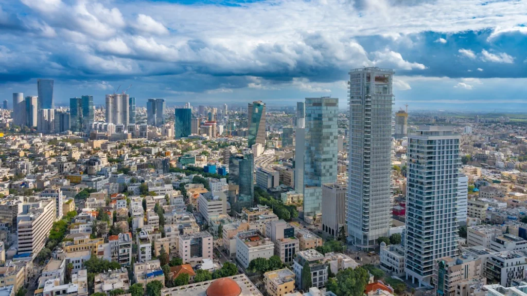Modern high-rise residential apartment buildings lining Rothschild Boulevard in Tel Aviv, Israel, with balconies and dense urban architecture typical of the area.