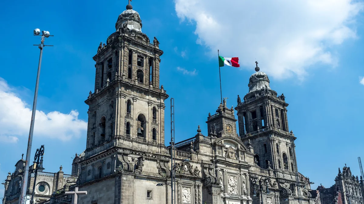 Facade of Mexico City's cathedral, with a Mexican flag waving