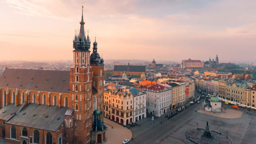 Aerial view of Kraków’s Old Town and Main Market Square in the morning sun, with St. Mary’s Basilica and the Cloth Hall, Poland.