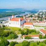 Panoramic aerial view of Bratislava, with its iconic castle overlooking the city.