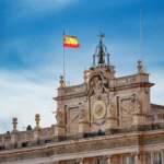 Spanish national flag flying above the Royal Palace of Madrid, Spain.