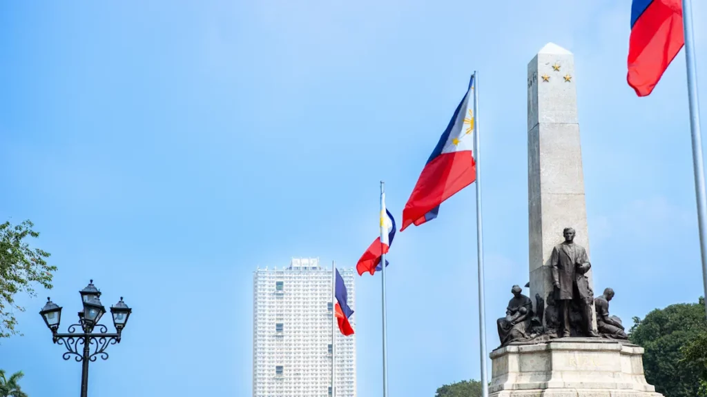 José Rizal Monument with the Philippine flag at Rizal Park in Manila, Philippines.